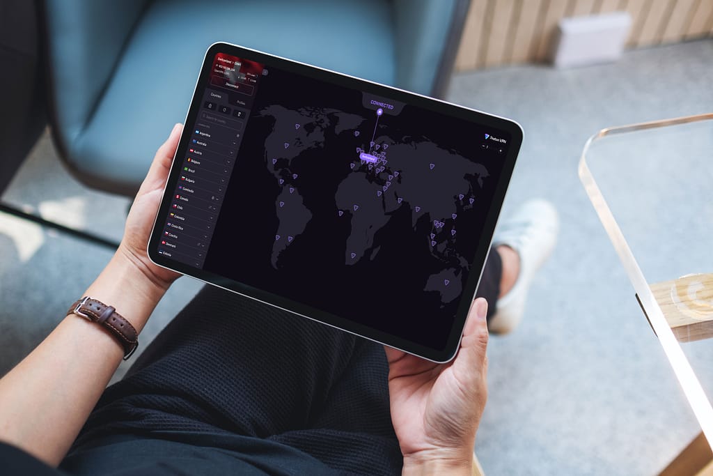 Person using tablet with world map with Proton VPN