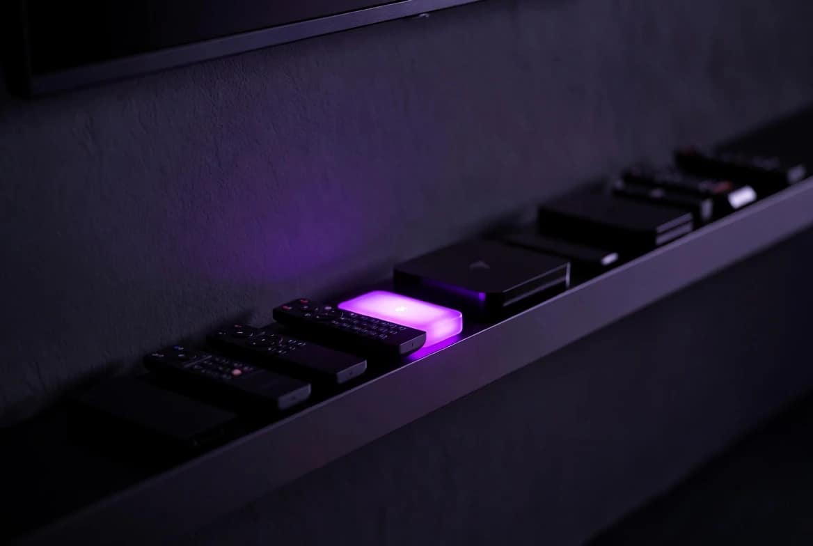How to Bypass HBO Max Household Detection Row of identical streaming devices with one glowing violet, illustrating how to bypass HBO Max household device recognition